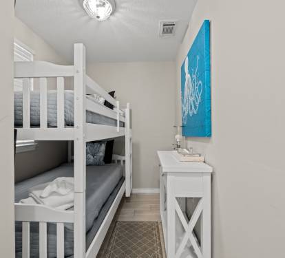 Bunk bedroom w/ crisp white beds, great for kids or extra guests.