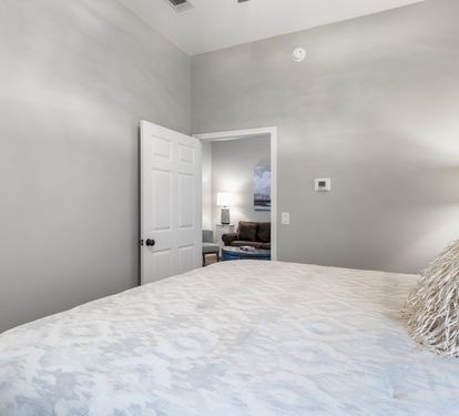  Bedroom with plush bedding and soft coastal lighting