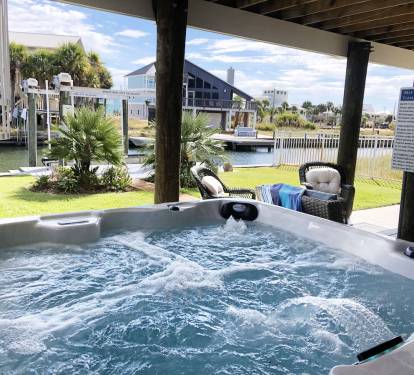 Welcome to Your WATERFRONT Island Retreat with PRIVATE Hot Tub & Backyard Oasis!