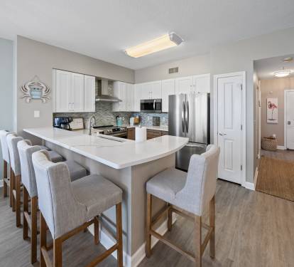 Luxury kitchen with quartz countertops and newer stainless appliances