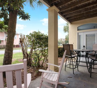 Covered patio with outdoor dining and garden views
