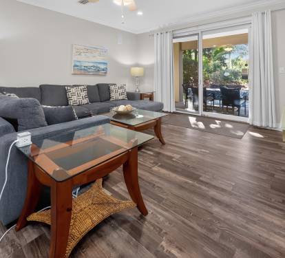 Bright living room w/ cozy seating and warm wood floors for easy gathering
