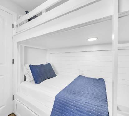 Custom-built Twin XL bunks offer a cozy, space-saving retreat—perfect for kids or extra guests to rest and recharge.