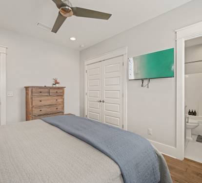 King Suite featuring a plush king bed and wall-mounted TV