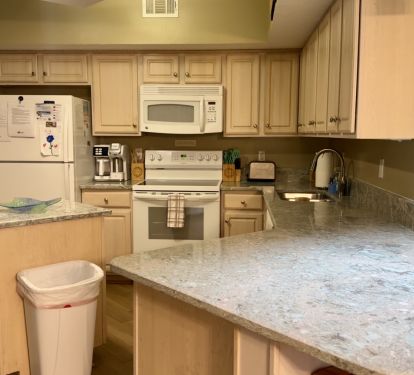 Fully Stocked kitchen with coffee pot, many options for pans, and dishwasher.