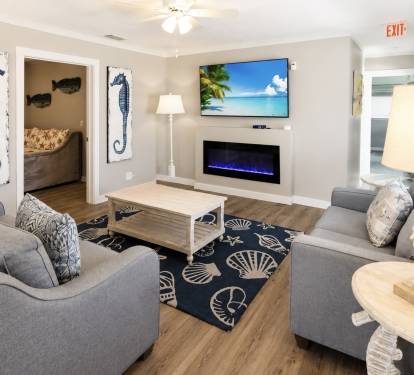The living room features a love seat, a sleeper sofa, an electric fireplace, and a Roku TV
