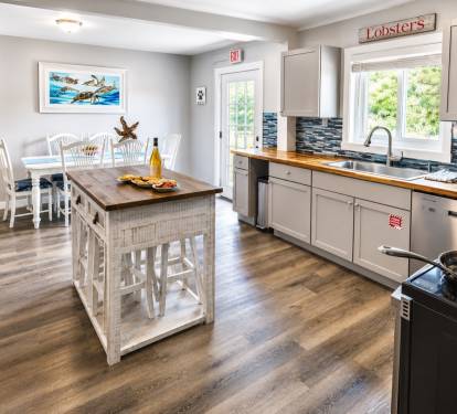 The full kitchen offers a dining room table, a breakfast bar with four stools, and an island table with 4 stools.  I has all the basic kitchen needs.  
