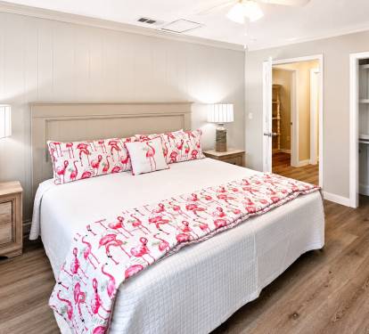 A King Suite with an en-suite full bathroom features a private primary bedroom with a king-size bed and an attached, dedicated full bathroom.  
