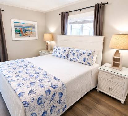 A King Suite with an en-suite full bathroom features a private primary bedroom with a king-size bed and an attached, dedicated full bathroom.  