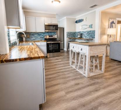 The full kitchen offers a dining room table, a breakfast bar with four stools, and an island table with 4 stools.  I has all the basic kitchen needs.  