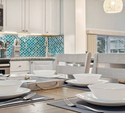 Dining table seats up to 6 guests with six bar stools surrounding the bar.