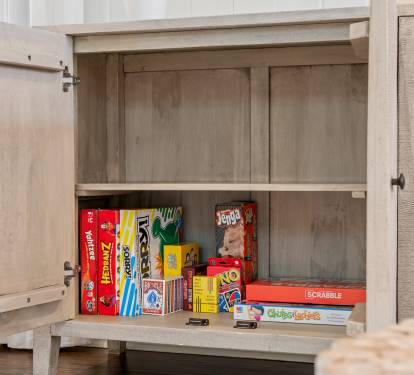 Game cabinet stocked w/ classic board games, perfect for laid-back nights in.