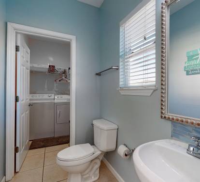 Half bathroom leads to washer and dryer room