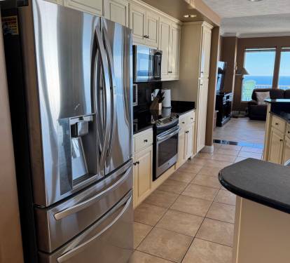 Large fridge with new oven.