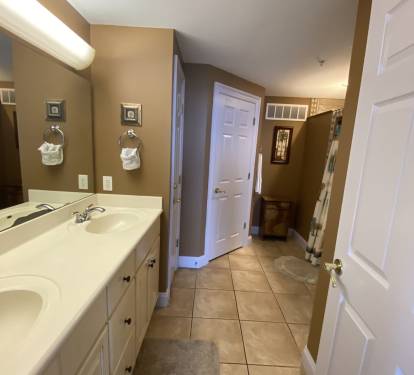 Master ensuite with double sinks, large walk-in closet &amp; newly tiled shower.