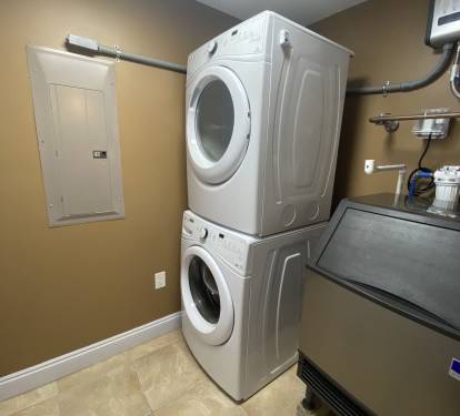 Laundry room with large commercial ice machine inside of your unit!