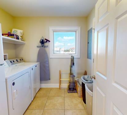 Laundry room with extra refrigerator