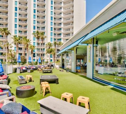 Lively outdoor hangout area w/ seating, games, and an open lawn atmosphere.
