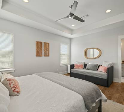 Grand Master King Suite with king bed, tray ceiling, ceiling fan, and seating area.
