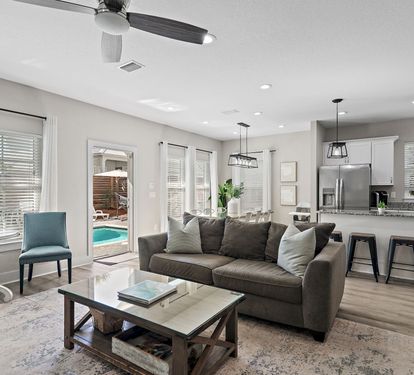 Living room opens directly to the pool area.