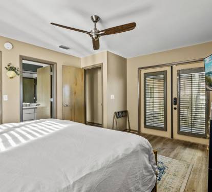 This king guest bedroom has a private bathroom entrance and connects to the deck. From every room, you can enjoy the panoramic views of the ocean, providing an idyllic retreat for a relaxing s