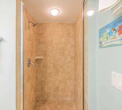Walk-in tiled shower offering a simple, refreshing space to rinse off after the day