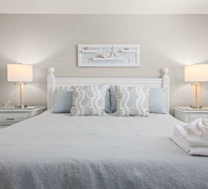 King-size bed centered under soft lighting for a peaceful night’s rest.