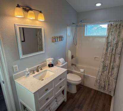 Jack-and-Jill Bathroom 3 offers a spacious shared layout with dual bedroom access, a full tub and shower combo, and bright coastal touches throughout.