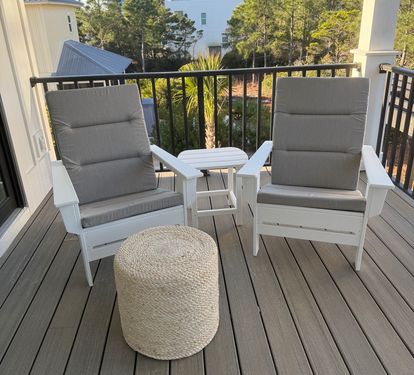 Gather on the upper back porch with room for the whole group — two separate seating areas of Adirondack chairs, ottomans, and a swing bed tucked in for an afternoon nap.