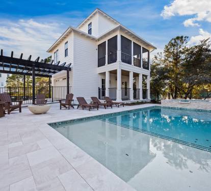 Private pool, spa, and patio oasis with Guest House views—featuring fire pit seating, multiple porches, and seamless indoor-outdoor coastal living.