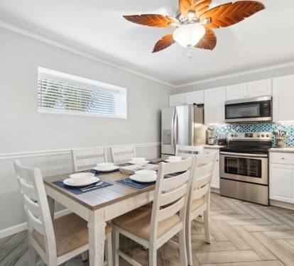 Dining table seats up to 6 guests with six bar stools surrounding the bar.