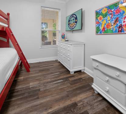 Bedroom w/ playful artwork and bold pops of color