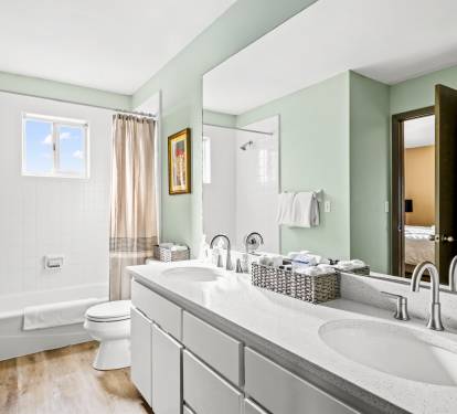 This full bathroom connects to a King bedroom and hallway. All bathrooms are bright and spacious, decorated in a sophisticated style.