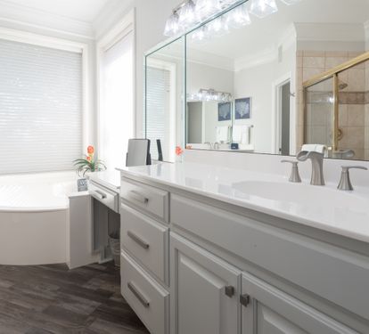 Spacious bathroom w/ a long vanity, clean sink, and bright natural light creating a calm, spa-like feel.