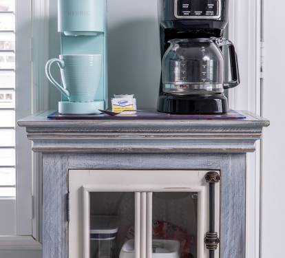 Start the day at the coffee bar, stocked with a brewer, Keurig, filters, grinder, ground coffee, pods, and sweeteners. Brew a cup, step outside, or settle in and ease into the morning.