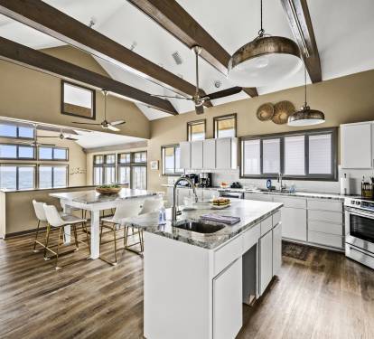 Cook and entertain in style in this open-plan kitchen with a large island, top-of-the-line amenities, and a seamless blend with the sitting area. Both areas offer stunning ocean views, making