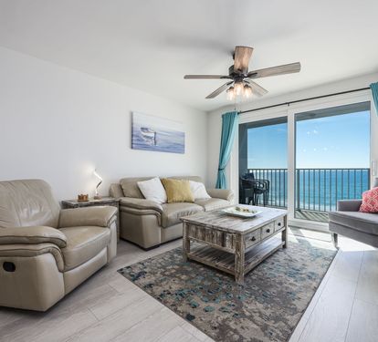 Living Room with Breathtaking Views Relax in this stylish living area, featuring plush seating, coastal decor, and a large flat-screen TV. The sliding glass doors lead to your private balcony,