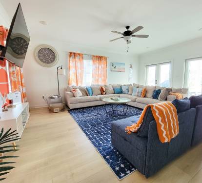 Another View of Living Room Where You Can See the Back Patio. Two Huge Glass Double Doors and Big Windows Invite a Lot of Natural Light into the Room