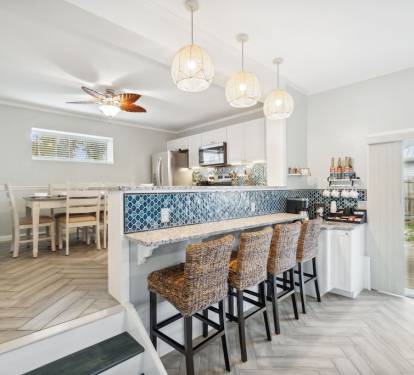 Dining table seats up to 6 guests with six bar stools surrounding the bar.