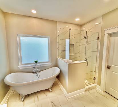 Master bathroom with tub and walk-in shower