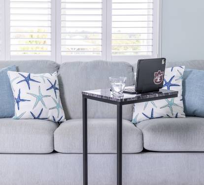 Sofa tables provide a comfortable spot for tablet or computer use while watching TV, making it easy to catch up on work or plan the day without leaving the living area.