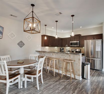Kitchen and dining area with seating for six and pendant lighting