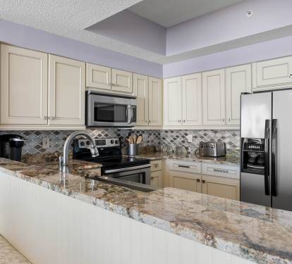 Modern kitchen layout w/ stainless appliances & clean, bright finishes.