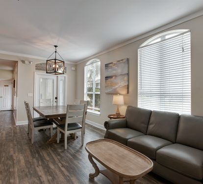  Living and dining spaces with warm wood flooring and bright windows