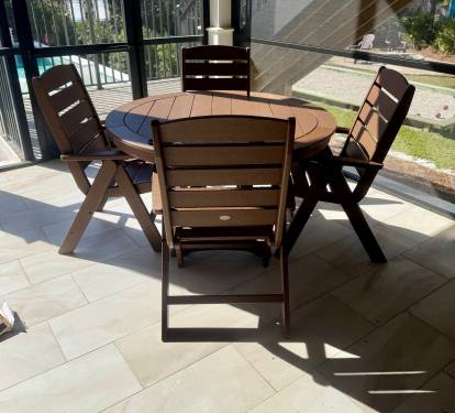 Covered outdoor dining for four—ideal for poolside snacks or as extended seating, expanding total dining capacity at the main house to 16 guests