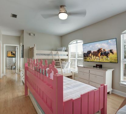 Bunk room with playful pink bunks and Smart TV