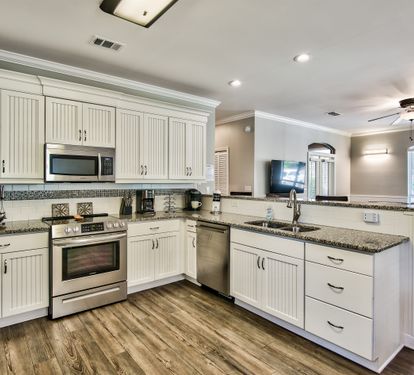 Kitchen with breakfast bar seating and open sightlines to the living room