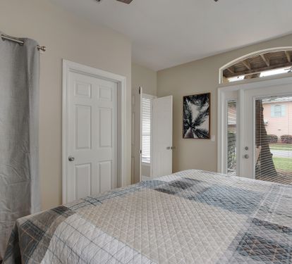  King bedroom with coastal bedding and natural light