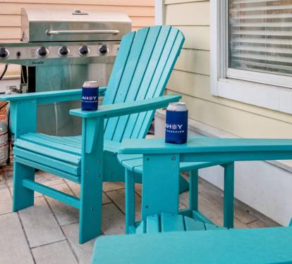 Two chairs, two koozies, and a grill at the ready.