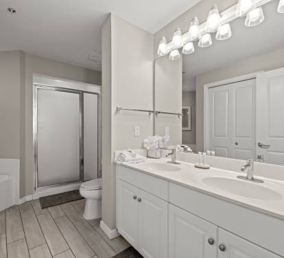 Bathroom w/ dual sinks, offering extra space for getting ready.